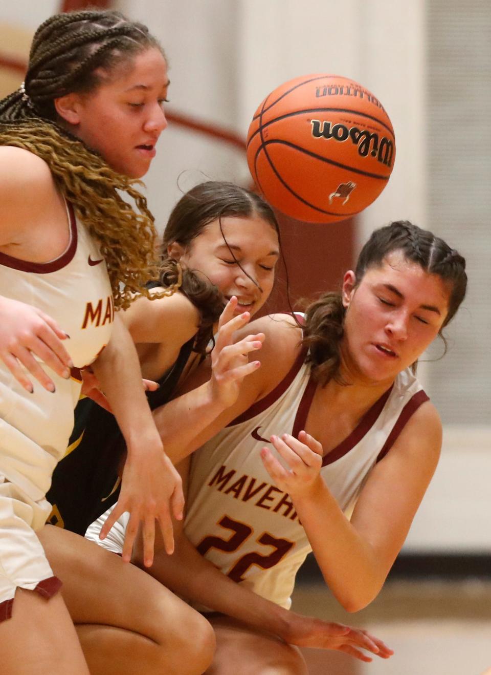 McCutcheon Mavericks forward Braelyn Williams (32), Benton Central Bison Keara Lipscomb-Allen (12) and McCutcheon Mavericks center Kalea Washington (22) collide going for a loose ball during the IHSAA girl’s basketball game, Thursday, Jan. 4, 2024, at McCutcheon High School in Lafayette, Ind. McCutcheon won 37-36.