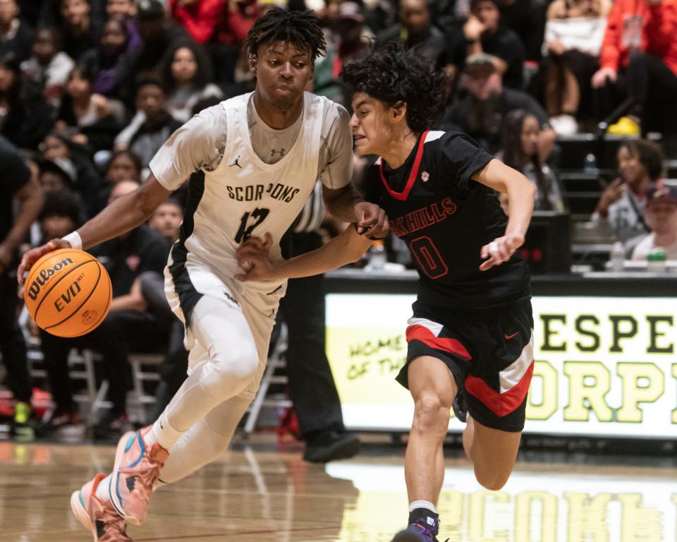 Hesperia’s Mark Jones dribbles the the ball while guarded by Oak Hills Jaylen Contreras on Wednesday, Jan. 17, 2024. Hesperia won 79-67 and improved to 5-0 in Mojave River League action.