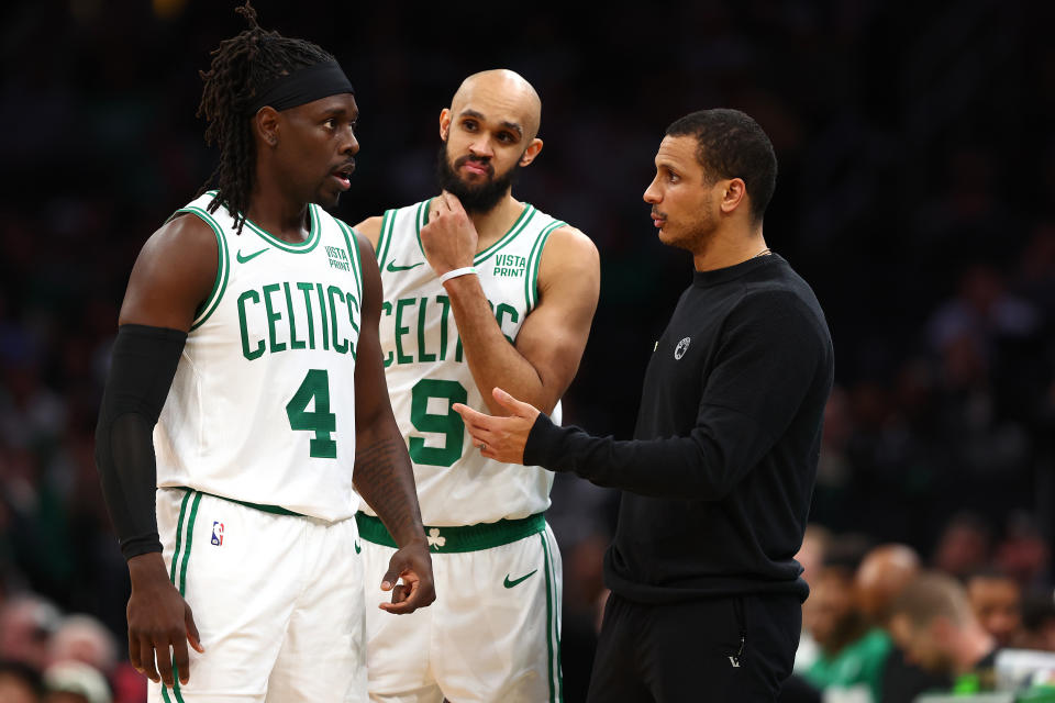 BOSTON, MASSACHUSETTS - JANUARY 10: Boston Celtics head coach Joe Mazzulla at TD Garden speaks with Jrue Holiday #4 and Derrick White #9 on January 10, 2024 in Boston, Massachusetts. The Celtics defeat the Timberwolves 127-120 in overtime. NOTE TO USER: User expressly acknowledges and agrees that, by downloading and or using this photograph, user is consenting to the terms and conditions of the Getty Images License Agreement.  (Photo by Maddie Meyer/Getty Images)