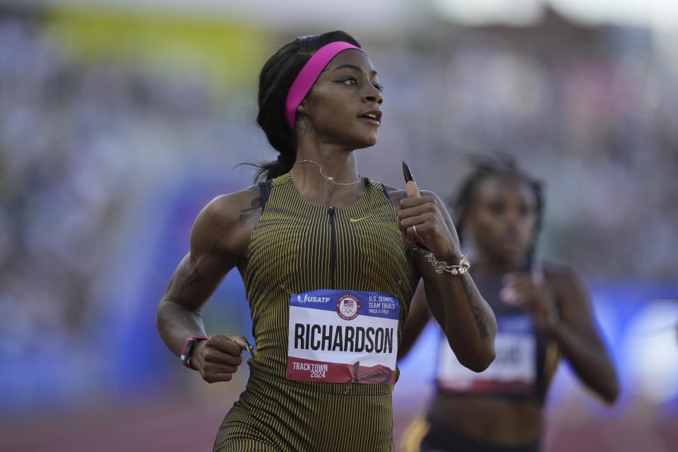 Sha'Carri Richardson wins a heat women's 100-meter run during the U.S. Track and Field Olympic Team Trials Friday, June 21, 2024, in Eugene, Ore. (AP Photo/Charlie Neibergall)