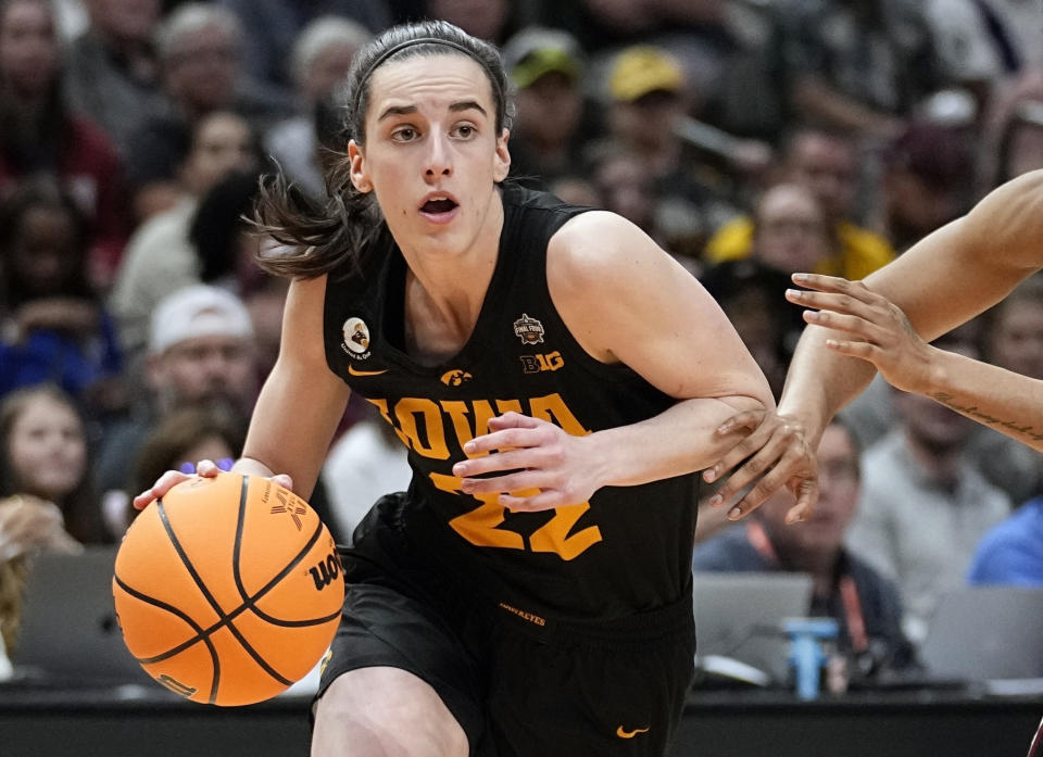 FILE - Iowa's Caitlin Clark gets past a South Carolina's defender during the second half of an NCAA Women's Final Four semifinal basketball game Friday, March 31, 2023, in Dallas. Clark needs 66 more points to break the NCAA career record of 3,527 by Washington's Kelsey Plum (2013-17). The Hawkeyes play Penn State at home on Thursday, Feb. 8, 2024. With an average of 32.4 points per game, Clark is on track to break the record at Nebraska on Sunday or Feb. 15 at home against Michigan.(AP Photo/Tony Gutierrez, File)