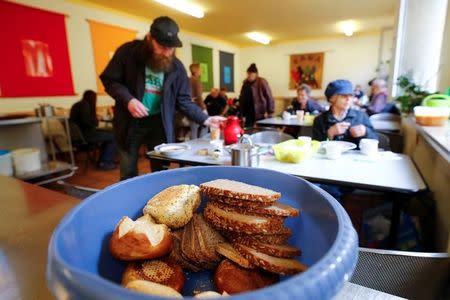 One day-old bread from a food bank lies in a basket as people in need eat a vegetable soup in the soup kitchen "Kana" in a poor district of the city of Dortmund, western Germany, April 7, 2017. Picture taken April 7, 2017. REUTERS/Wolfgang Rattay