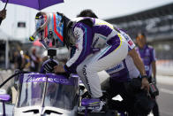 Takuma Sato, of Japan, climbs into his car during practice for the IndyCar auto race at Indianapolis Motor Speedway, Friday, May 13, 2022, in Indianapolis. (AP Photo/Darron Cummings)