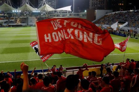 Hong Kong fans wave banners before a friendly soccer match between Hong Kong and Bahrain in Hong Kong, China November 9, 2017. REUTERS/Bobby Yip