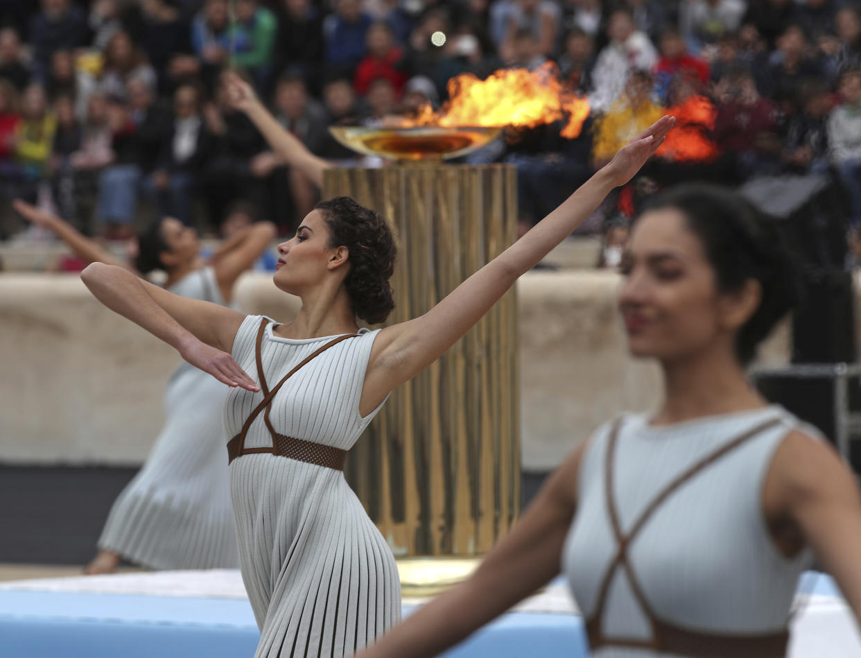 Dancers dressed as priestesses perform during a handover ceremony for the Olympic Flame at Panathenaic stadium in Athens, on Tuesday, Oct. 31, 2017. The South Korean leg of the relay will involve 7,500 torch-bearers, who will cover a total 2,018 kilometers (about 1260 miles) before the opening ceremony in Pyeongchang, which will host the Feb. 9-25, 2018 Winter Olympics. (AP Photo/Petros Giannakouris)