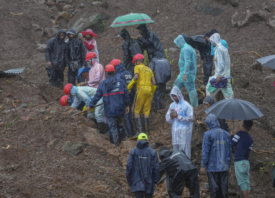 Rescuers try to take out the body of a victim at a site of a landslide triggered by torrential rains in Raigad district, western Maharashtra state, India, Thursday, July 20, 2023. While some people are reported dead many others feared trapped under piles of debris. (AP Photo/Rafiq Maqbool)