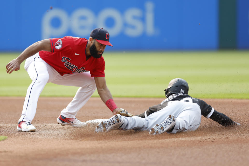 Cleveland Guardians shortstop Amed Rosario, left, tags out Chicago White Sox's Luis Robert Jr., right, who was attempting to steal second base during the first inning of a baseball game, Monday, May 22, 2023, in Cleveland. (AP Photo/Ron Schwane)