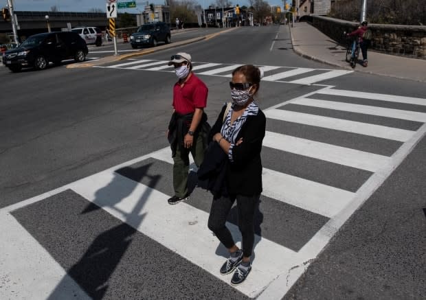 People walk in Ottawa in the midst of the COVID-19 pandemic on Sunday, May 17, 2020. 