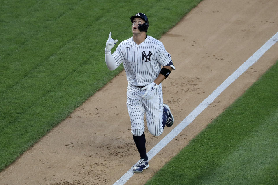 New York Yankees' Aaron Judge reacts as he approaches home plate after hitting a two-run home run during the third inning of the baseball game against the Boston Red Sox at Yankee Stadium, Friday, July 31, 2020, in New York. (AP Photo/Seth Wenig)