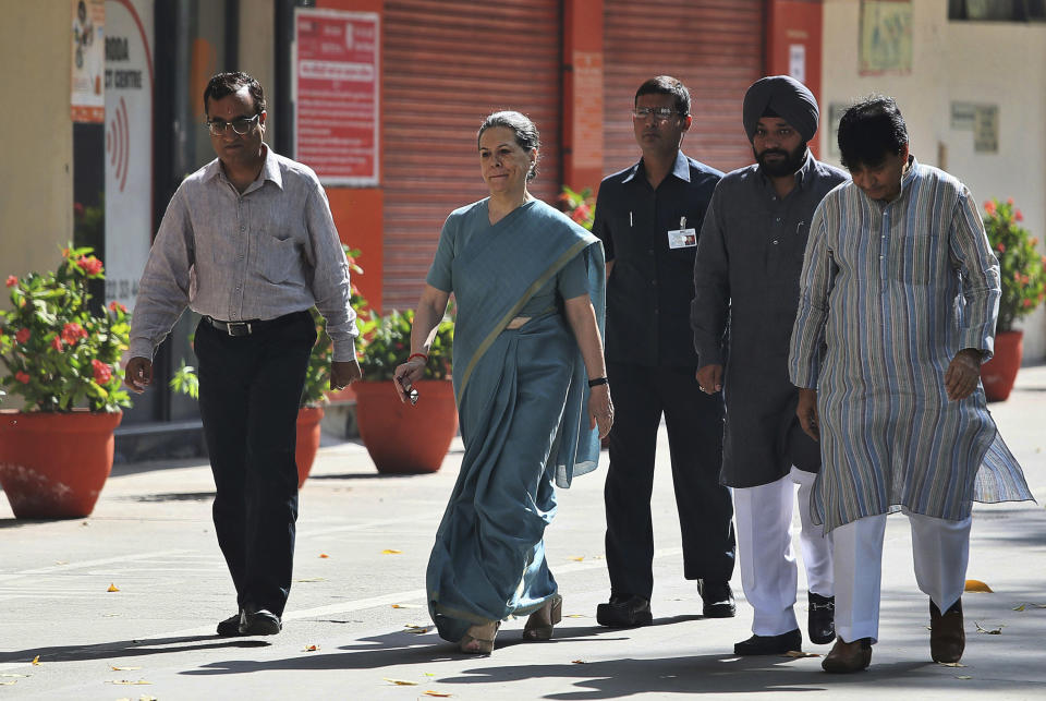 India’s ruling Congress party president Sonia Gandhi, second left, arrives to cast her vote during parliamentary elections in New Delhi, India, Thursday, April 10, 2014. Millions of people are voting in the third phase of the elections Thursday, covering parts of 11 of India's 28 states. The multiphase voting across the country runs until May 12, with results for the 543-seat lower house of parliament announced May 16. (AP Photo /Manish Swarup)