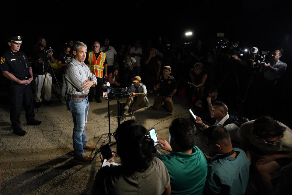 San Antonio Mayor Ron Nirenberg with San Antonio Police Chief William McManus, left, brief media and others at the scene where they said dozens of people have been found dead and multiple others were taken to hospitals with heat-related illnesses after a semitrailer containing suspected migrants was found, Monday, June 27, 2022, in San Antonio. (AP Photo/Eric Gay)