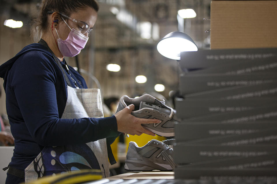 An employee in the New Balance factory in Methuen, Mass., holding a Made 990v5 shoe. - Credit: Courtesy of New Balance