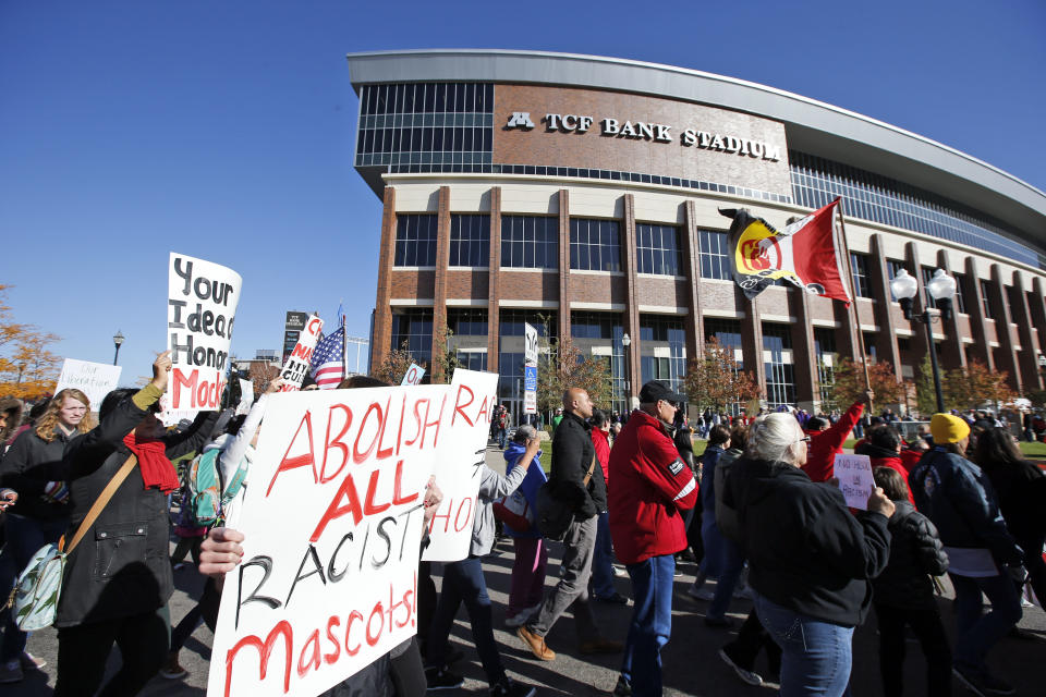 FILE - A "No Honor in Racism Rally" marches in front of TCF Bank Stadium before an NFL football game between the Minnesota Vikings and the Kansas City Chiefs, on Oct. 18, 2015, in Minneapolis. The group objects to the Kansas City Chiefs name, and other teams' use of Native Americans as mascots. As the Kansas City Chiefs return to Super Bowl on Sunday, Feb. 12, 2023, for the first time in two years, the movement to change their name and logo will be there again. (AP Photo/Alex Brandon, File)