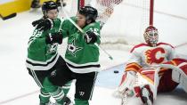 Dallas Stars' Joe Pavelski (16) and Vladislav Namestnikov (92) celebrate a after Pavelski scored against Calgary Flames goaltender Jacob Markstrom (25) during the third period of Game 3 of an NHL hockey Stanley Cup first-round playoff series Saturday, May 7, 2022, in Dallas. The Stars won 4-2. (AP Photo/Tony Gutierrez)