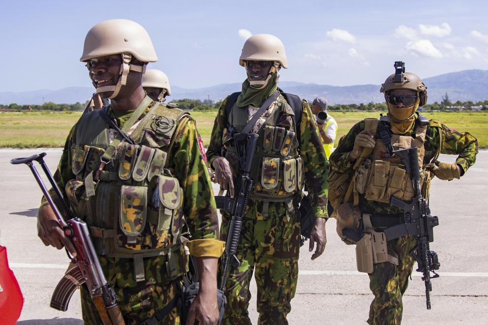 Police from Kenya stand at the Toussaint Louverture International Airport after landing in Port-au-Prince, Haiti, Tuesday, June 25, 2024. The first U.N.-backed contingent of foreign police arrived nearly two years after the Caribbean country requested help to quell a surge in gang violence. (AP Photo/Marckinson Pierre)