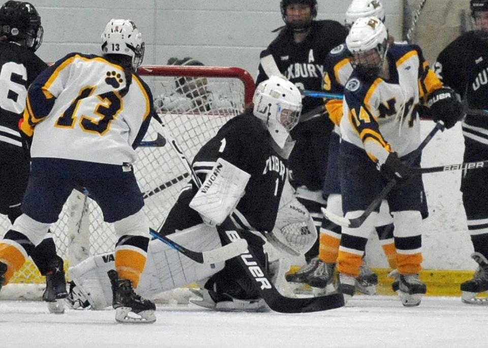 Duxbury goalie Anna McGinty, center, stops the shot of Notre Dame Academy's Lauren White, right, during the Tenney Girls Winter Classic at The Bog in Kingston, Monday, Dec. 26, 2022.