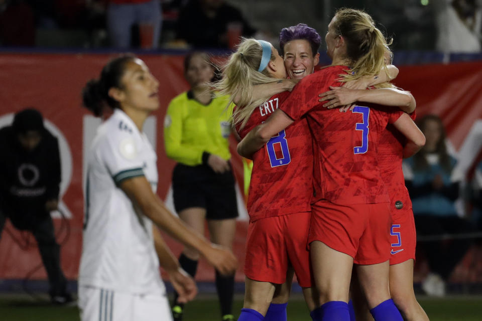 U.S. players, including Megan Rapinoe, facing camera, and Julie Ertz, left, celebrate after a goal by midfielder Samantha Mewis (3) during the first half of a CONCACAF women's Olympic qualifying soccer match against Mexico on Friday, Feb. 7, 2020, in Carson, Calif. (AP Photo/Chris Carlson)