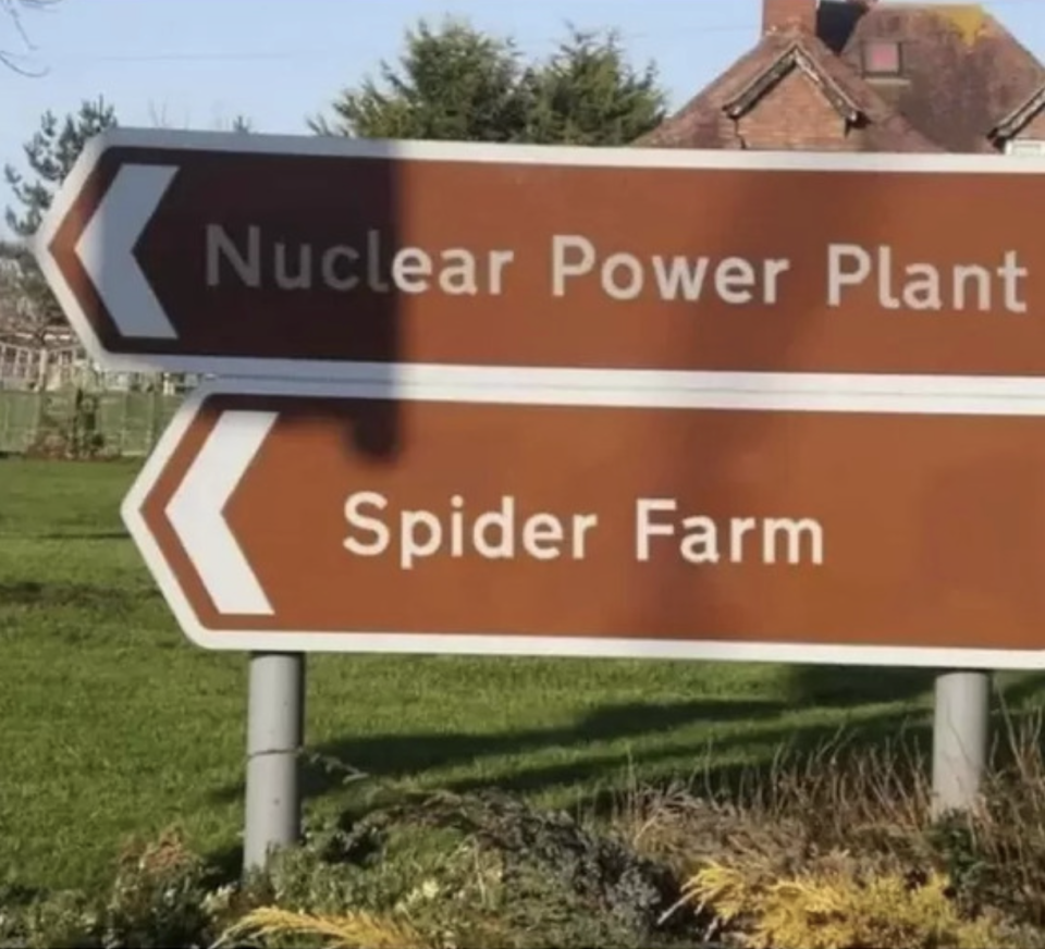 Street directional signs: "Nuclear Power Plant" and "Spider Farm"