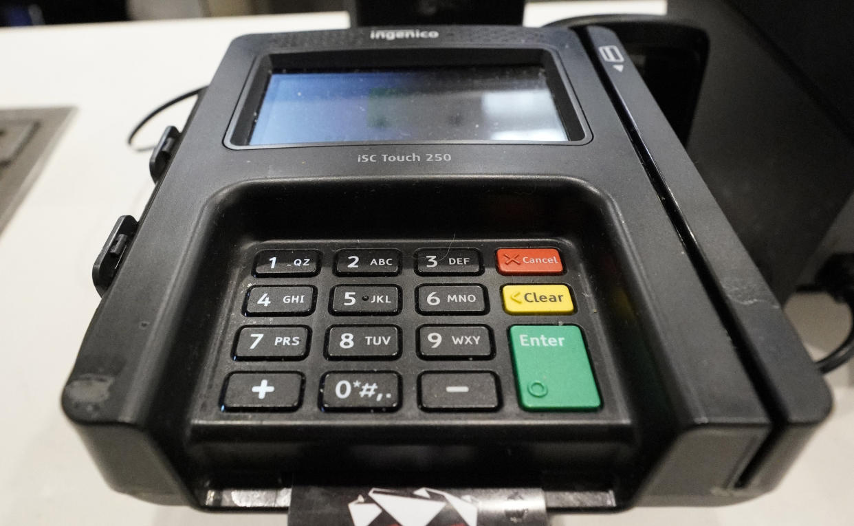 FILE- In this Jan. 29, 2019, file photo a credit card machine is shown at Mercedes-Benz Stadium during a tour for the NFL Super Bowl 53 football game in Atlanta. On Thursday, Feb. 7, the Federal Reserve releases its October report on consumer borrowing. (AP Photo/David J. Phillip, File)