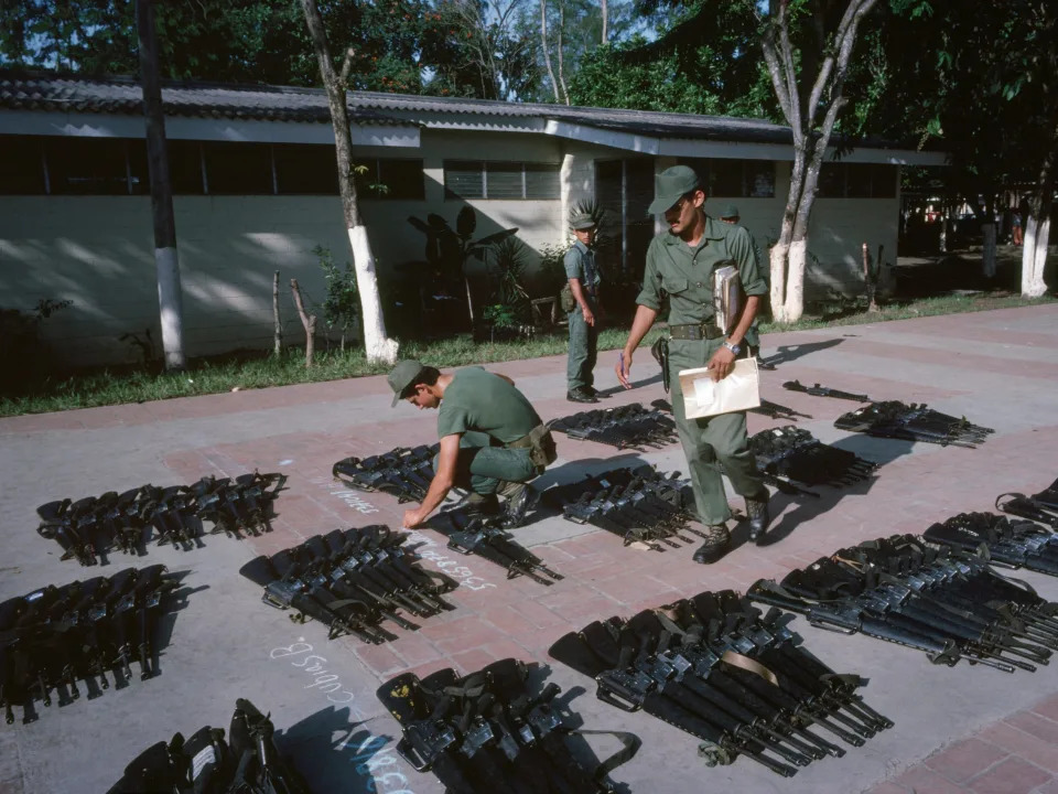 An army instructor inspects US-made M16 rifles during a training exercise in El Salvador in 1982.