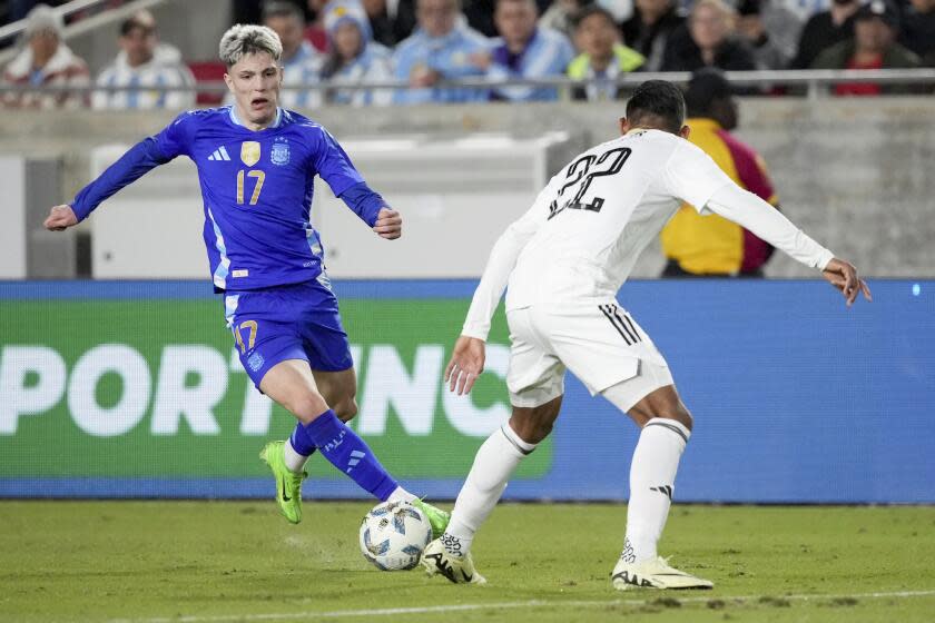 Argentina midfielder Alejandro Garnacho (17) dribbles the ball against Costa Rica defender Haxel Quiros (22) during the first half of an international friendly soccer match Tuesday, March 26, 2024, in Los Angeles. (AP Photo/Eric Thayer)