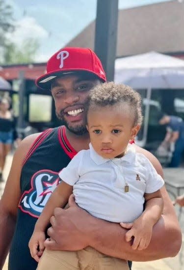 Caleb Gilliam, 29, smiles while holding his cousin. His family called him a "good-hearted man" who was "full of laughter" and "had the brightest smile."