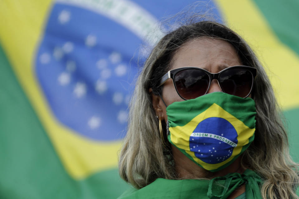 A supporter of Brazilian President Jair Bolsonaro takes part in a gathering to commemorate the 1964 military coup that established a decades-long dictatorship, in the Ministries Esplanade in Brasilia, Brazil, Wednesday, March 31, 2021. The leaders of all three branches of Brazil's armed forces jointly resigned on Tuesday following Bolsonaro's replacement of the defense minister, causing widespread apprehension of a military shakeup to serve the president's political interests. (AP Photo/Eraldo Peres)