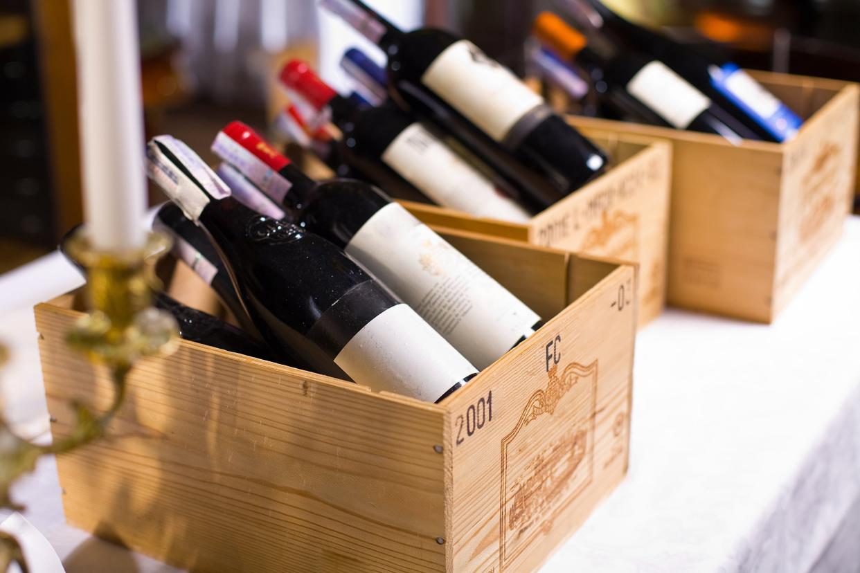 wine bottles in wooden boxes are on the table restaurant