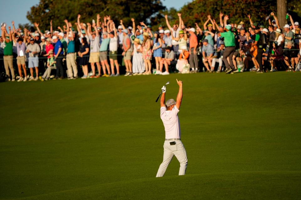 Bryson DeChambeau celebrates his birdie from the 18th fairway during the third round of the Masters on April 13 at the Augusta National Golf Club.