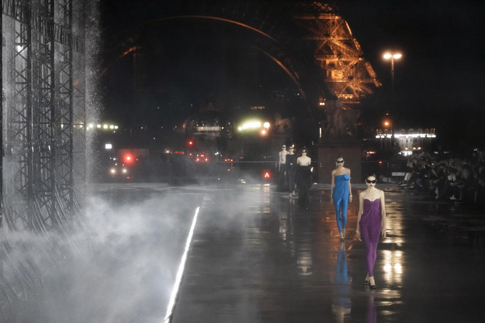 Models wear creations for Saint Laurent Spring-Summer 2022 ready-to-wear fashion show presented Tuesday, Sept. 28, 2021, in Paris. (AP Photo/Thibault Camus)