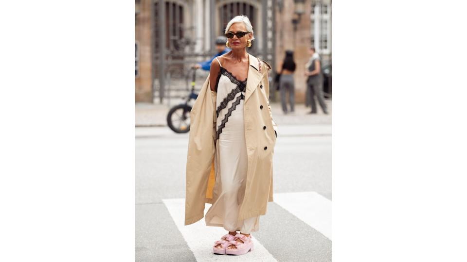 Grece Ghanem wears fantastic pink sandals, a white and black lace slip dress and a classic trench coat.