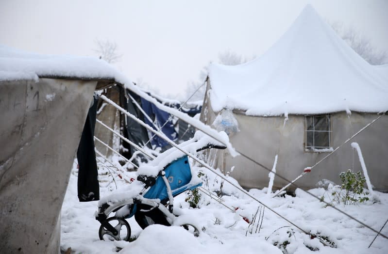 A stroller is covered with snow at a makeshift forest camp near Croatian border in Bihac