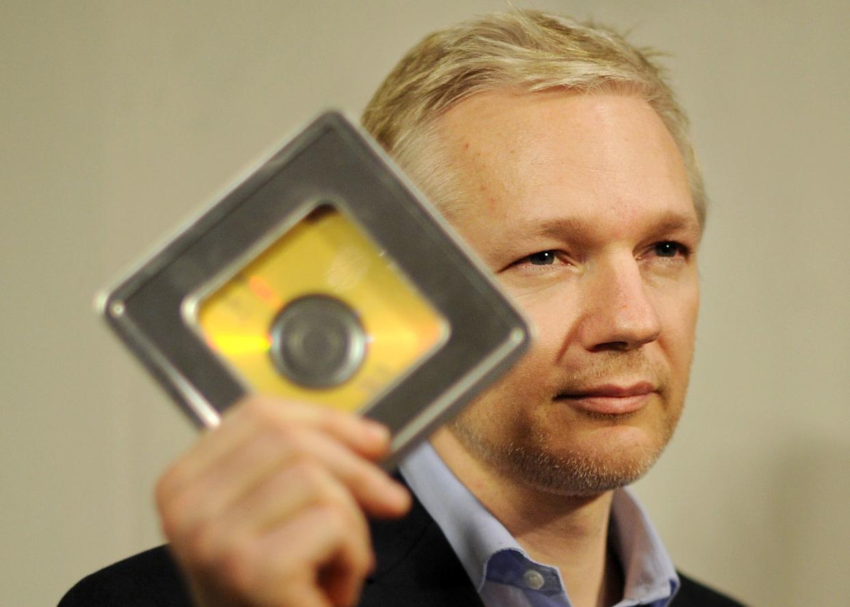 WikiLeaks founder Julian Assange holds a CD containing data given by former Swiss banker Rudolf Elmer (not pictured) following a press conference in London, on January 17, 2011. Swiss whistleblower Rudolf Elmer handed over to Assange two CDs containing data of around 2,000 bank clients who may have been evading taxes, according to an interview published that Sunday.