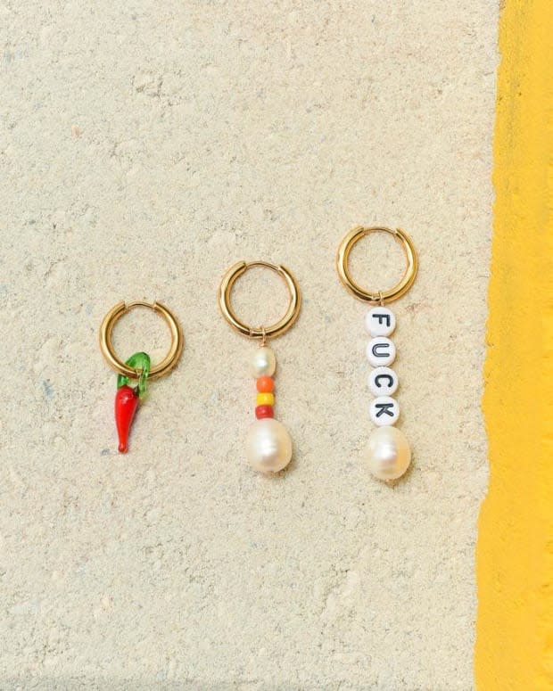 Éliou Trio Earring Pack "Fuck, It's Hot," $135, <a href="https://www.eliou-eliou.com/collections/earrings/products/copy-of-all-the-feels-earring-damn" rel="nofollow noopener" target="_blank" data-ylk="slk:available here;elm:context_link;itc:0;sec:content-canvas" class="link ">available here</a>.<br>