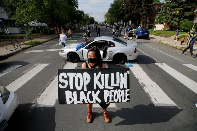 Protesters gather at the scene where George Floyd was arrested by police officers in Minneapolis