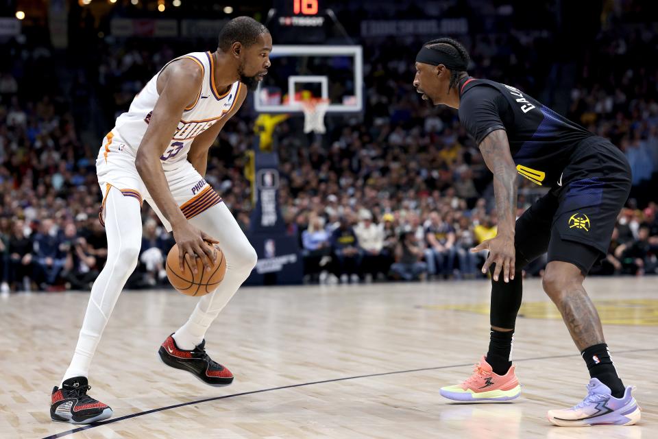 Kevin Durant #35 of the Phoenix Suns is guarded by Kentavious Caldwell-Pope #5 of the Denver Nuggets during the first quarter at Ball Arena on March 27, 2024 in Denver, Colorado.