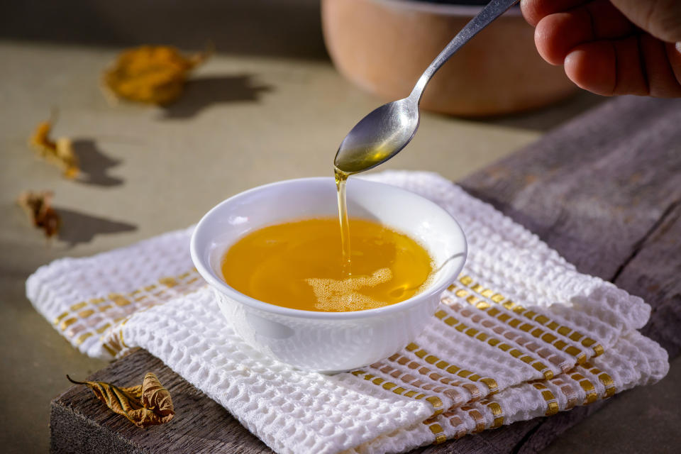 Ghee butter from India in white dinnerware container on wooden table. (cacio murilo de vasconcelos / Getty Images/iStockphoto)