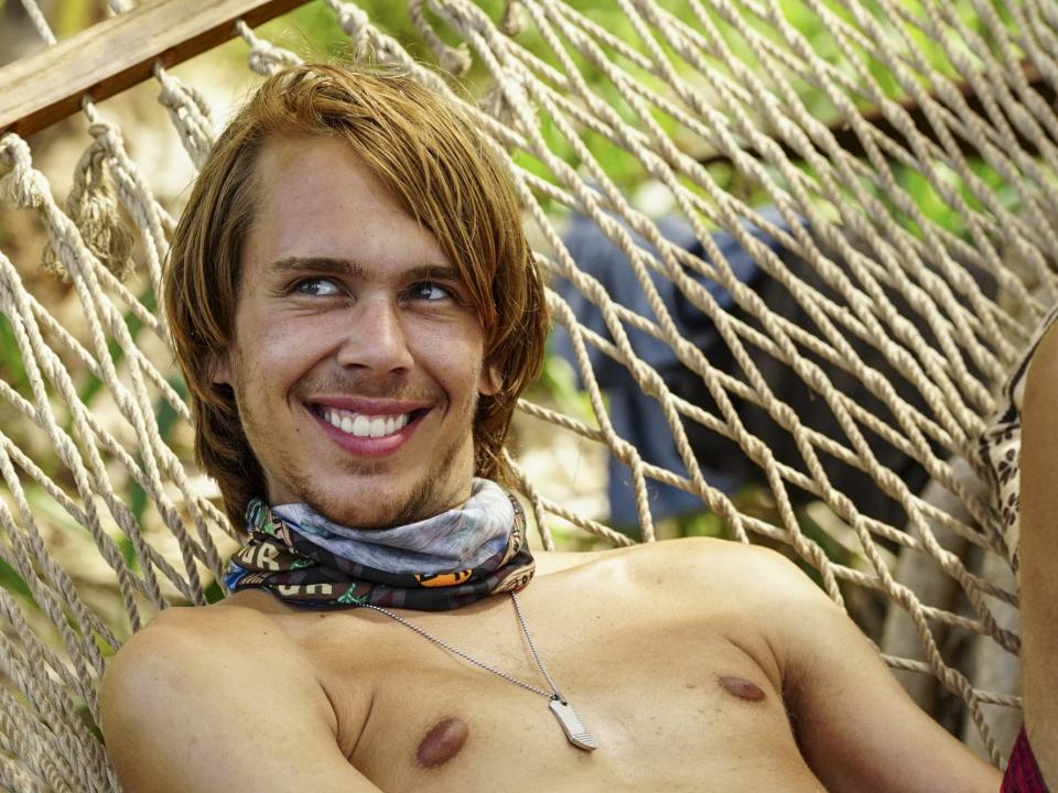 Will Wahl sitting in a hammock with a buff around his neck on Survivor