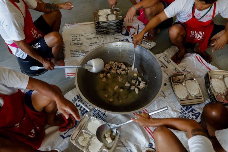 Drug rehab patients prepare food at the Mega Drug Abuse Treatment and Rehabilitation Center, in Nueva Ecija province, north of Manila