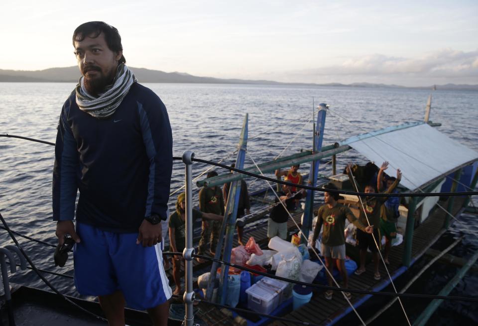 First Lt. Mike Pelotera of the Philippine Marines and fellow marines who were deployed five months ago on board the dilapidated navy ship LT57 BRP Sierra Madre off the disputed Second Thomas Shoal, locally known as Ayungin Shoal, on the South China Sea, arrive at a naval base in Palawan for awarding ceremony Monday, March 31, 2014 in southwestern Philippines. On Saturday, China Coast Guard attempted to block the Philippine government vessel AM700 carrying fresh troops to relieved the Nine marines as well as supplies, but the latter successfully managed to dock beside the ship housing the troops. (AP Photo/Bullit Marquez)