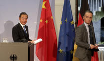 German Foreign Minister Heiko Maas, right, and China's Foreign Minister Wang Yi, left, leave after a joint press conference as part of a meeting in Berlin, Germany, Tuesday, Sept. 1, 2020. (AP Photo/Michael Sohn, pool)