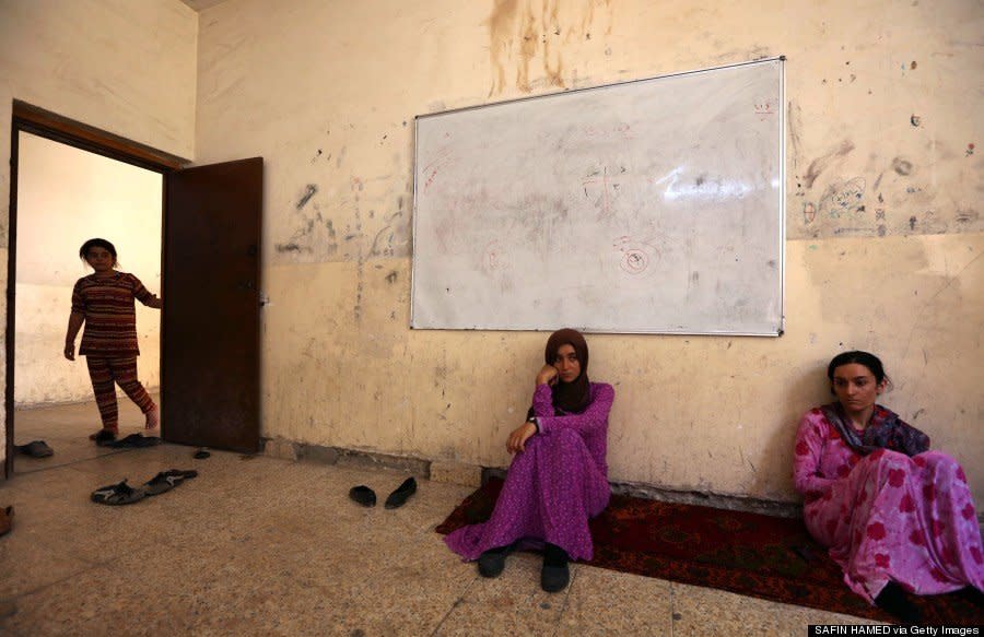 Yazidi women who fled violence in northern Iraq sit at a school where they are taking shelter in Dohuk on August 5, 2014. (SAFIN HAMED/AFP/Getty Images) 