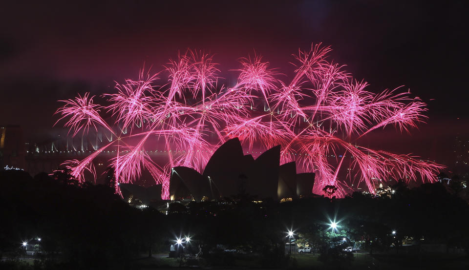 Fireworks explode behind the Opera House during the New Year celebrations in Sydney, Australia, Tuesday, Jan. 1, 2013.(AP Photo/Rob Griffith)