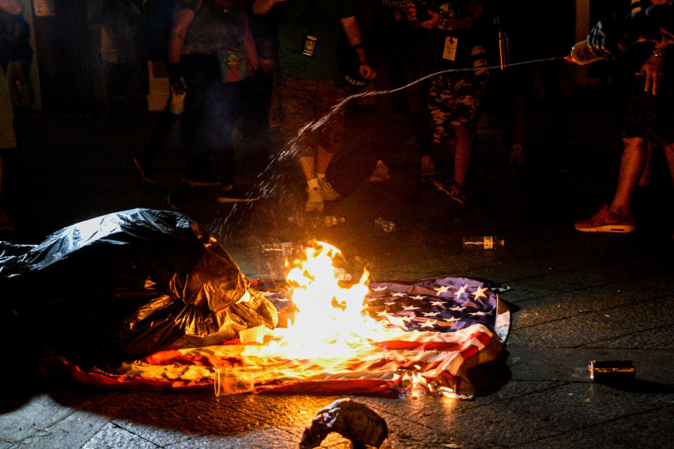 Demonstrators burn a U.S. flag during clashes with police on the fifth day of protests calling for the resignation of Governor Ricardo Rossello in San Juan, Puerto Rico July 17, 2019.  (Photo: Gabriella N. Baez/Reuters)