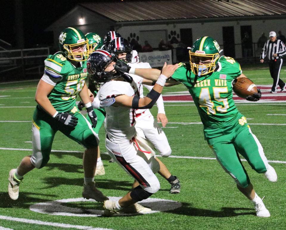 Newark Catholic's Mikey Hess carries the ball during the Green Wave's 49-0 win over Zanesville Rosecrans on Oct. 28.