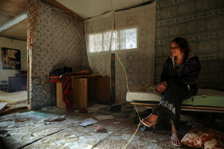 Veronica Radu, 24, sits in her bedroom as she waits to be relocated from the Roma shanty town of El Gallinero, on the outskirts of Madrid, Spain, September 27, 2018. REUTERS/Susana Vera