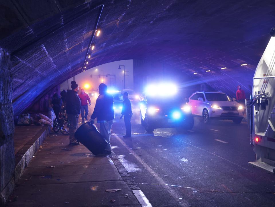 Brockton city workers clean under the School Street bridge where people who are homeless are staying on Tuesday, Dec. 26, 2023.