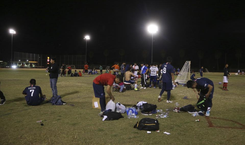 Players pack up after a Maya Chapin soccer league game Wednesday, April 17, 2019, in Phoenix. (AP Photo/Ross D. Franklin)