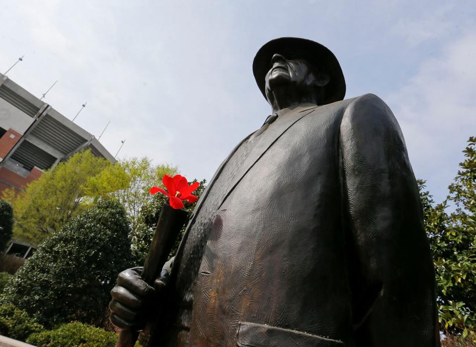 Spring is beginning to show its glory on the campus at the University of Alabama Tuesday, March 17, 2020. Someone placed a tulip on the statues of Bear Bryant and Nick Saban as well as the other coach statues on the Walk of Champions. [Staff Photo/Gary Cosby Jr.]