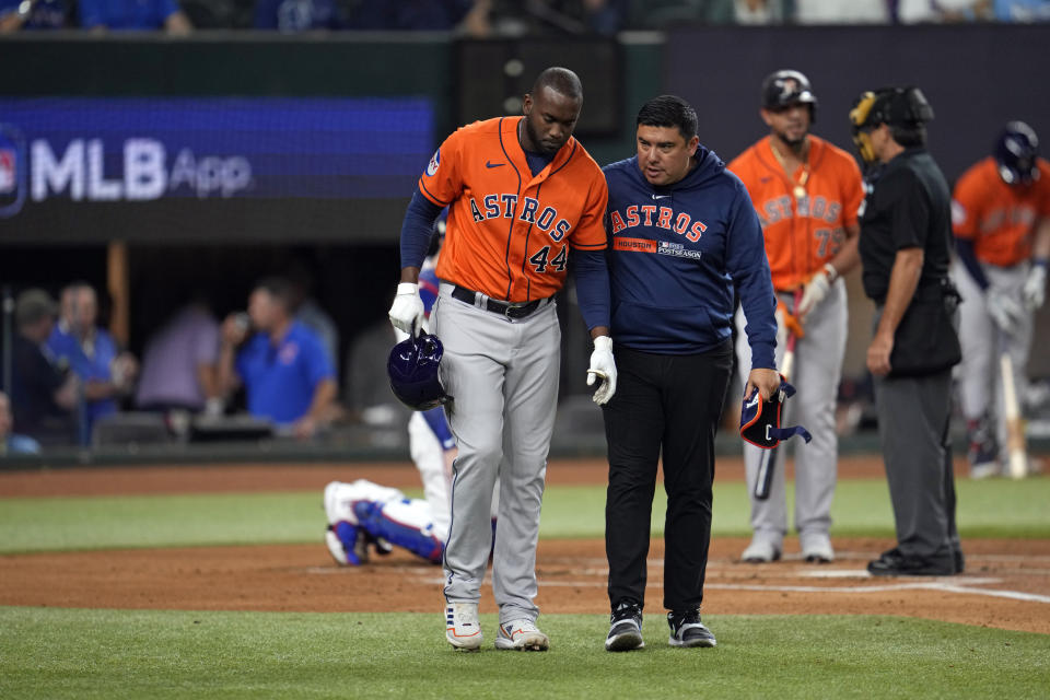 Houston Astros' Yordan Alvarez (44) is helped after being hit by a pitch thrown by Texas Rangers starting pitcher Max Scherzer during the second inning in Game 3 of the baseball American League Championship Series Wednesday, Oct. 18, 2023, in Arlington, Texas. (AP Photo/Godofredo A. Vasquez)